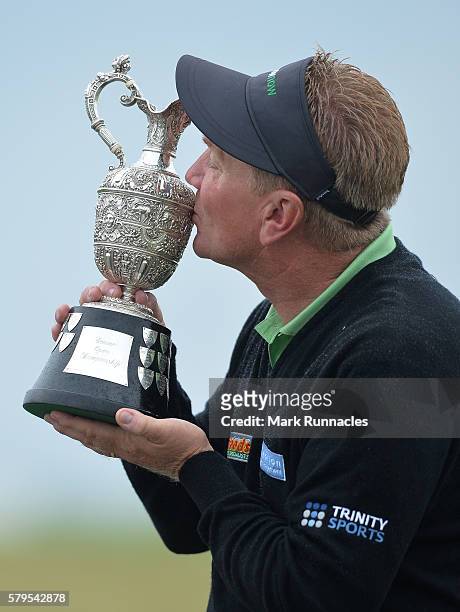Paul Broadhurst of England Senior Open Trophy after holing his final putt on 18 to win The Senior Open Championship at Carnoustie Golf Club on July...