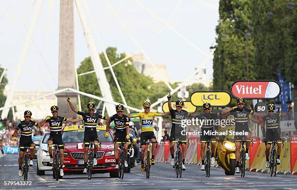 Chris Froome of Great Britain and Team Sky crosses the finishing line with the rest of Team Sky following victory during stage twenty one of the 2016...