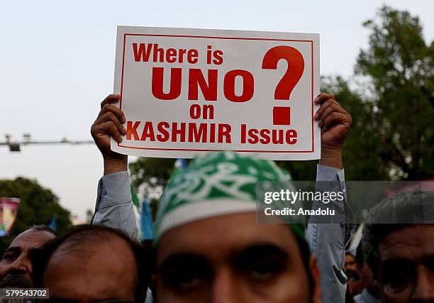 Banner is seen during a protest, held against killing of Burhan Muzaffar Wani, leader of Hizbul Mujahideen in Kashmir by Jamaat-e-Islami, in...