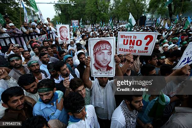 People hold photographs of leader of Hizbul Mujahideen Burhan Muzaffar Wani during a protest, held against killing of Burhan Muzaffar Wani in Kashmir...