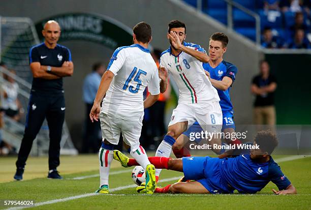 Mauro Coppalaro of Italy is challenged by Dennis Will Poha of France during the UEFA Under19 European Championship Final match between U19 France and...