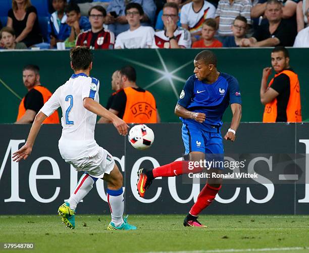 Kylian Mbappe of France is challenged by Davide Vitturini of Italy during the UEFA Under19 European Championship Final match between U19 France and...