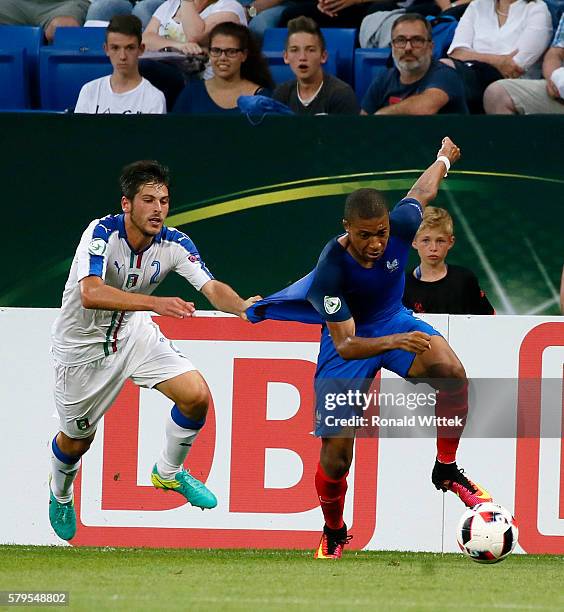 Kylian Mbappe of France is challenged by Davide Vitturini of Italy during the UEFA Under19 European Championship Final match between U19 France and...