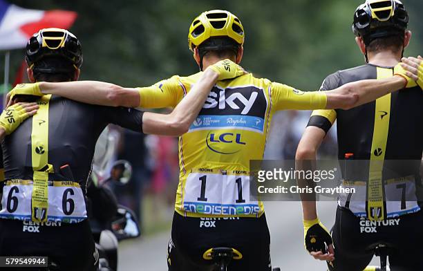 Chris Froome of Great Britain and Team Sky links arms wit Wout Poels of the Netherlands and Team Sky and Luke Rowe of Great Britain and Team Sky...