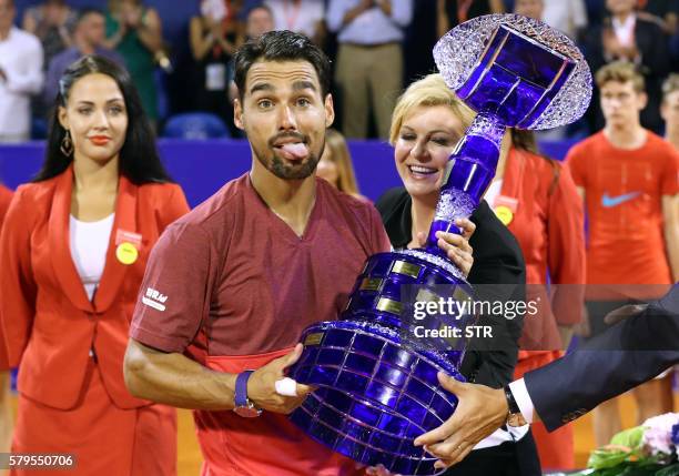 Italian player Fabio Fognini holds the trophy after winning the ATP Croatia Open tennis tournament final match on July 24, 2016 in the Croatian...