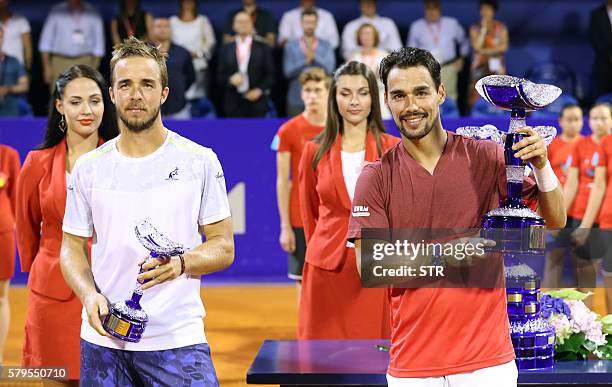 Italian player Fabio Fognini holds the winning trophy next to Slovakian player Andrej Martin after the ATP Croatia Open tennis tournament final match...