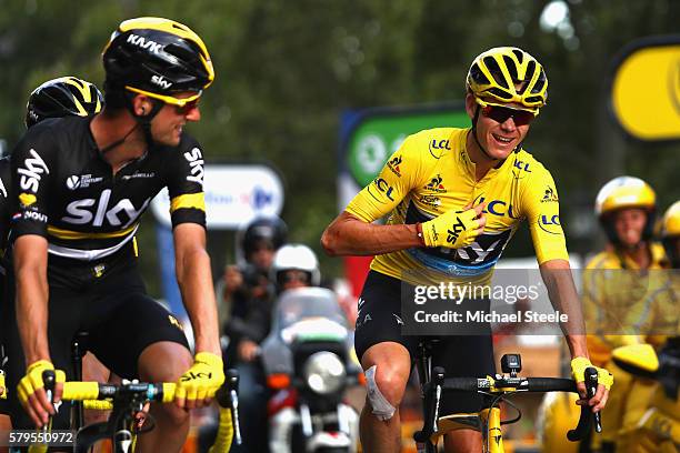 Chris Froome of Great Britain and Team Sky celebrates as he crosses the finish line in stage twenty one of the 2016 Le Tour de France, from Chantilly...