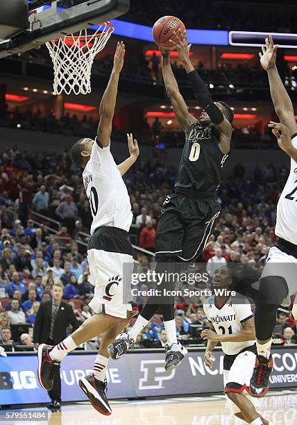 Purdue Boilermakers guard Jon Octeus misses a dunk attempt over Cincinnati Bearcats guard Troy Caupain in a second-round NCAA Tournament game between...