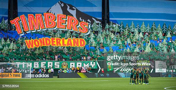 Timbers Army hold up signs as their team celebrates during the Seattle Sounders versus the Portland Timbers at Providence Park in Portland, OR.