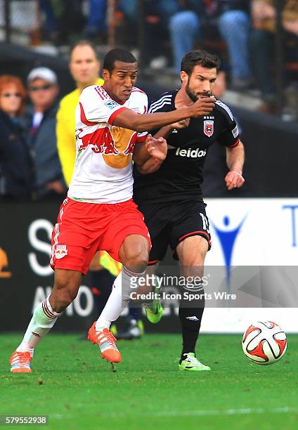 New York Red Bulls defender Roy Miller duels for the ball with D.C. United midfielder/forward Chris Pontius during the MLS Eastern Conference...