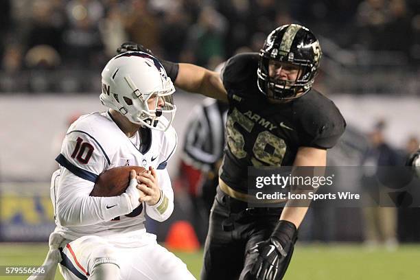 Army Black Knights Defensive Lineman John Voit smothers Uconn Huskies Quarterback Chandler Whitmer during a NCAA football game between the UConn...
