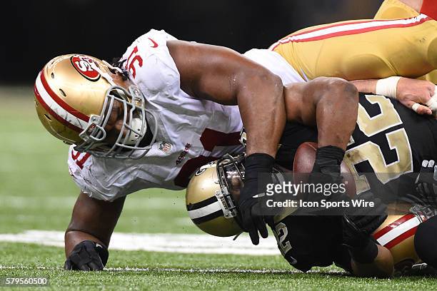 San Francisco 49ers Defensive End Ray McDonald [9373] tackles New Orleans Saints Running Back Mark Ingram [4107] in action during a game between the...