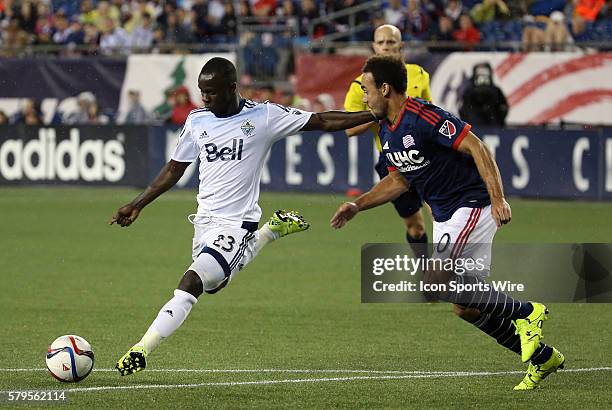 Vancouver Whitecaps midfielder Kekuta Manneh tries a shot marked by New England Revolution defender Kevin Alston . The Vancouver Whitecaps defeated...