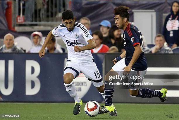 New England Revolution midfielder Lee Nguyen watched by Vancouver Whitecaps midfielder Matias Laba . The Vancouver Whitecaps defeated the New England...