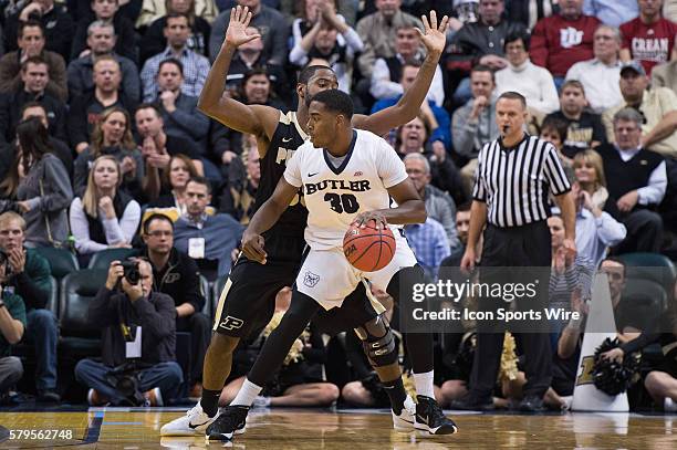 Purdue Boilermakers guard Rapheal Davis defends Butler University forward Kelan Martin during the Crossroads Classic NCAA basketball game between the...