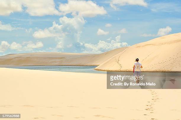 girl walking the dunes in lencois maranhenses national park, brazil - lencois maranhenses national park stock pictures, royalty-free photos & images
