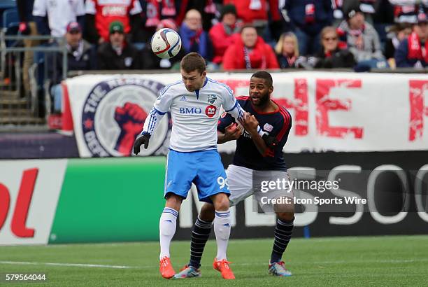 Montreal Impacts' Jack McInerney heads the ball away from New England Revolution's Andrew Farrell . The New England Revolution and the Montreal...