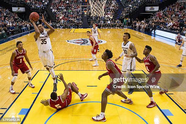 Notre Dame Fighting Irish forward Bonzie Colson shoots over a fallen down Indiana Hoosiers forward Troy Williams during the Crossroads Classic NCAA...