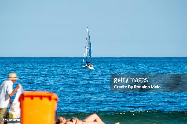boat background and woman sunbathing on the beach - comprimento fotografías e imágenes de stock
