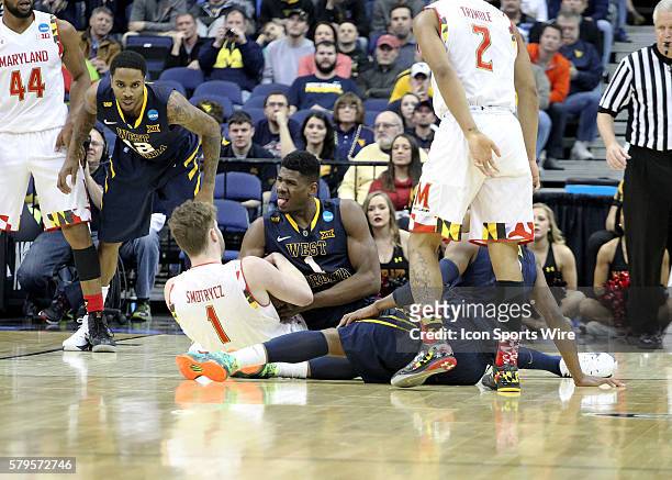 March 22, 2015; West Virginia Mountaineers forward Jonathan Holton and Maryland Terrapins forward Evan Smotrycz battle for the ball during the game...