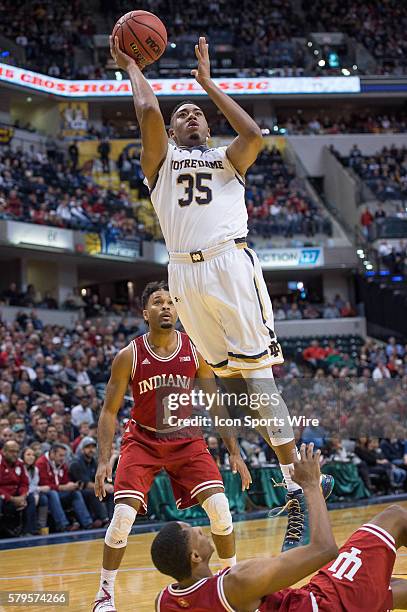 Notre Dame Fighting Irish forward Bonzie Colson shoots over Indiana Hoosiers forward Troy Williams during the Crossroads Classic NCAA basketball game...