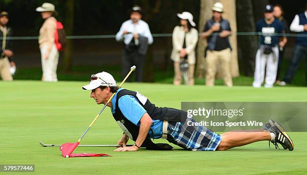 Paula Creamer's caddie gets down to read a putt for his golfer. Lorena Ochoa Invitational Golf Tournament, Mexico City, Mexico