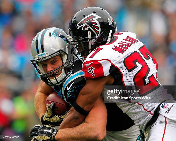 Carolina Panthers tight end Greg Olsen is tackled by Atlanta Falcons cornerback Robert McClain in first half action of the Atlanta Falcons at...