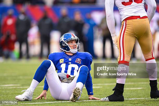 New York Giants quarterback Eli Manning looks up at San Francisco 49ers outside linebacker Aldon Smith after getting hit hard during the first half...