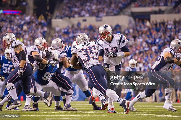 New England Patriots quarterback Tom Brady hands off to New England Patriots running back Jonas Gray during a football game between the Indianapolis...