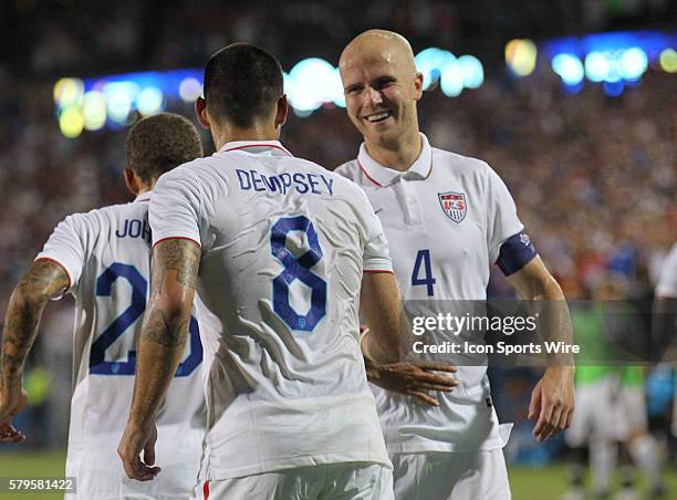 Forward Clint Dempsey and USA midfielder Michael Bradley celebrate Dempsey's 2nd goal during the Gold Cup Group Stage match between the USA and...