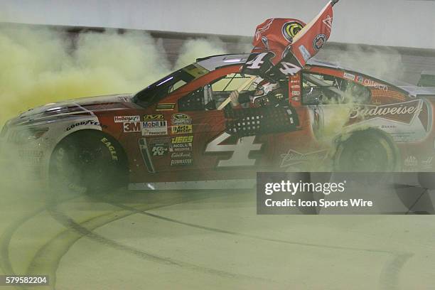 Kevin Harvick, driver of the No.4 Budweiser Chevy, celebrates winning the Sprint Cup Championship and the NASCAR Sprint Cup Series - Ford EcoBoost...