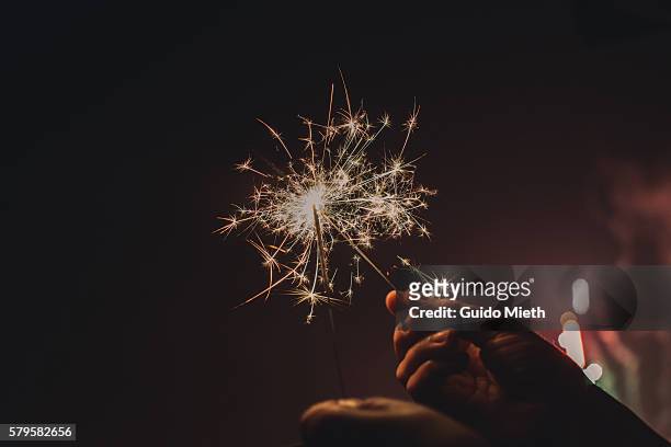 woman holding sparkler. - sparklers stock pictures, royalty-free photos & images