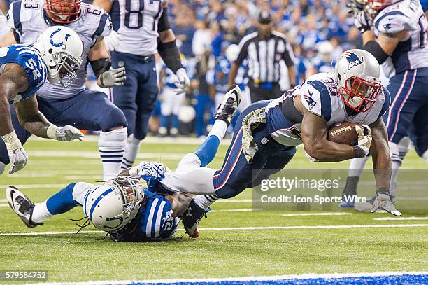 Indianapolis Colts cornerback Greg Toler tackles New England Patriots running back Jonas Gray during a football game between the Indianapolis Colts...