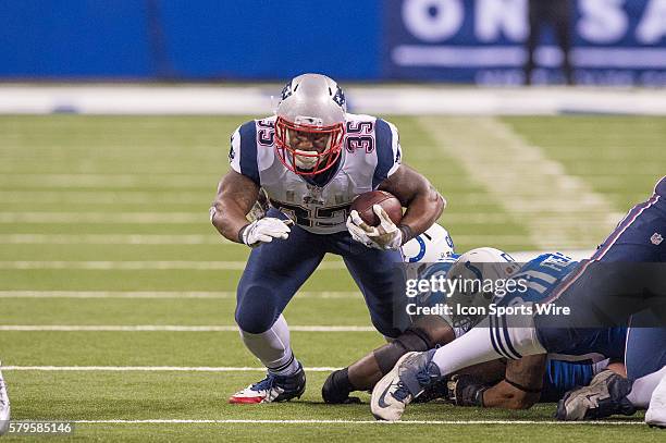 Indianapolis Colts nose tackle Josh Chapman trips up New England Patriots running back Jonas Gray during a football game between the Indianapolis...