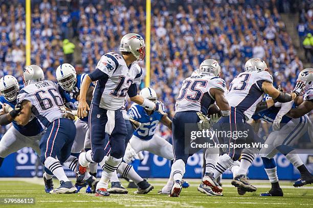 New England Patriots quarterback Tom Brady hands off to New England Patriots running back Jonas Gray during a football game between the Indianapolis...