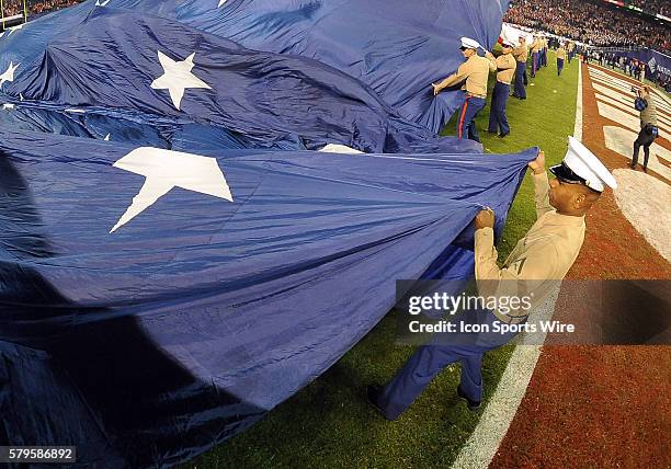 The Marines role out a big flag for the national anthem before the start of the Holiday Bowl game played between the Wisconsin Badgers and the USC...