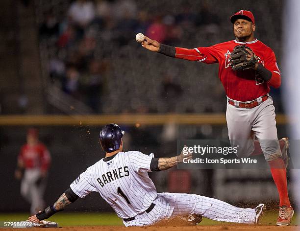 Los Angeles Angels shortstop Erick Aybar attempts to turn a double play over a sliding Colorado Rockies left fielder Brandon Barnes during a regular...