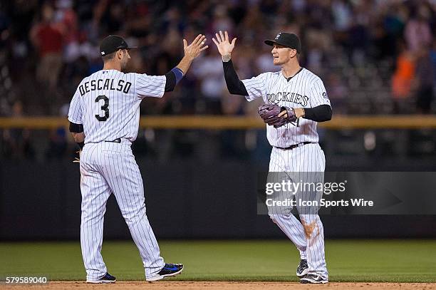 Colorado Rockies left fielder Brandon Barnes and shortstop Daniel Descalso celebrate a win during a regular season Major League Baseball game between...