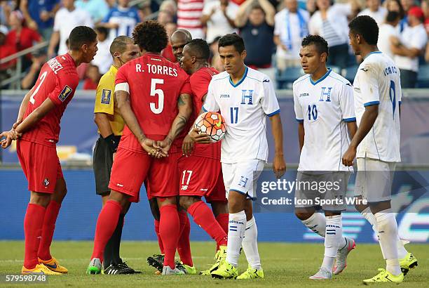 Honduras midfielder Andy Najar heads to the penalty spot as Panama clusters around Referee Marlon Mejia after the penalty call. The Men's National...