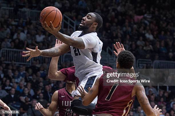 Butler University guard Roosevelt Jones drives by IUPUI Jaguars guard T.J. Henderson for a layup during the NCAA basketball game between the Butler...