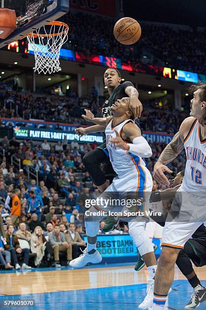 Oklahoma City Thunder Guard Russell Westbrook [1973] gets fouled by Milwaukee Bucks Center John Henson [3253] in game at Chesapeake Energy Arena in...