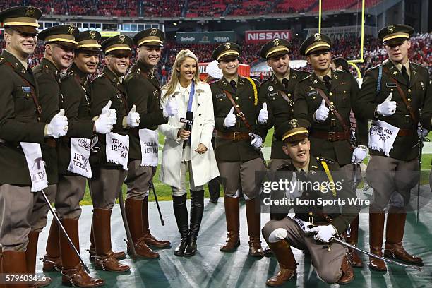 S Laura Rutledge and the Texas A&M mid-shipmen pose for a photo before the Franklin American Mortgage Music City Bowl match-up between Texas A&M and...