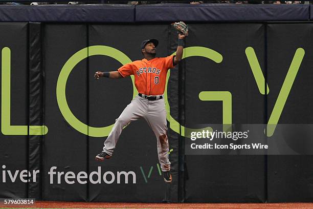 Houston Astros right fielder L.J. Hoes leaps to make a leaping catch to steal a hit from Tampa Bay Rays third baseman Evan Longoria in the 4th inning...