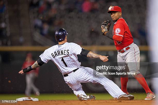 Los Angeles Angels shortstop Erick Aybar attempts to turn a double play over a sliding Colorado Rockies left fielder Brandon Barnes during a regular...