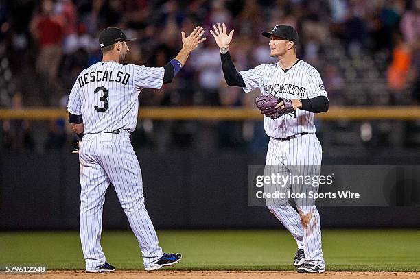 Colorado Rockies left fielder Brandon Barnes and shortstop Daniel Descalso celebrate a win during a regular season Major League Baseball game between...