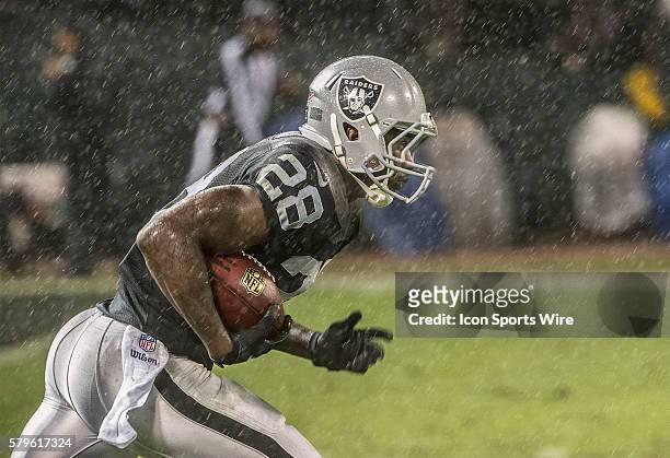 November 20, 2014 Oakland Raiders running back Latavius Murray makes run in the rain on Thursday, November 20 at O.co Coliseum in Oakland,...