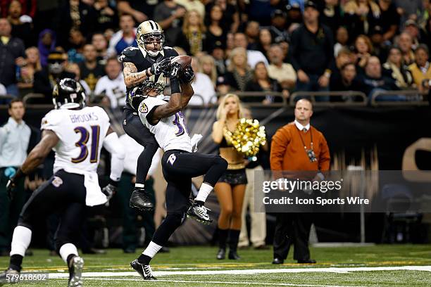 New Orleans Saints wide receiver Kenny Stills reaches over Baltimore Ravens defensive back Danny Gorrer to catch the ball at the Mercedes-Benz...