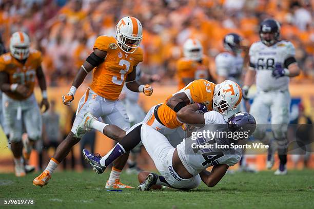 Northwestern receiver Christian Jones drops a pass and takes a hit from LaDarrell McNeil of Tennessee during the Outback Bowl football game between...