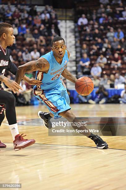 Florida State Seminoles guard Aaron Thomas tries to get past the defender during the Florida State game against Massachusetts at Mohegan Sun in...