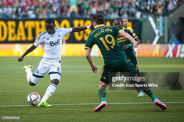 Kekuta Manneh of Vancouver Whitecaps shoots on goal closely marked by Jorge Vilafa??a of Portland Timbers- Providence Park, Portland, OR